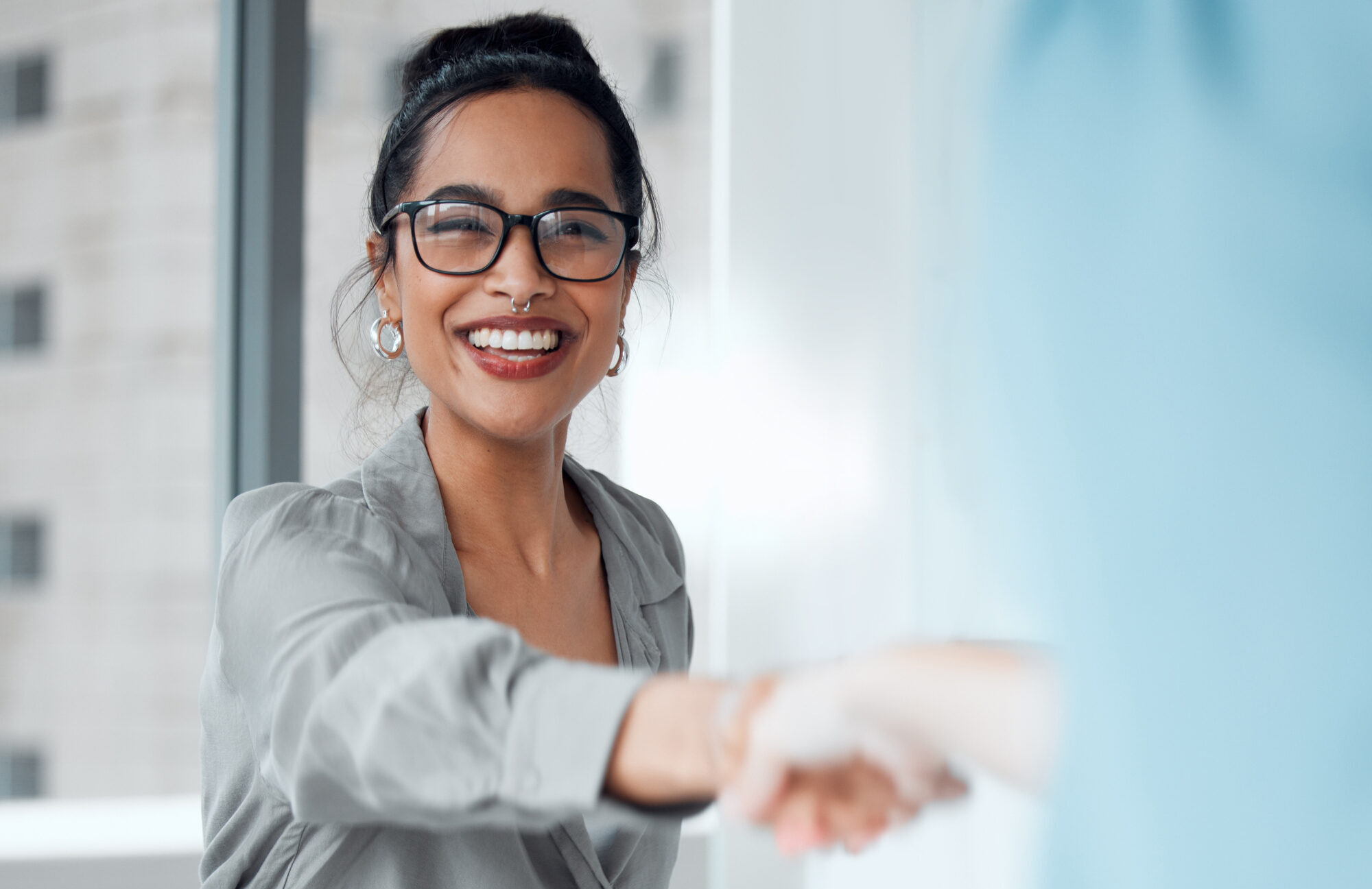 handshake, meeting and welcome with business woman in office for human resources, hiring or recruitment. contract, interview and partnership with happy employee shaking hands for b2b collaboration
